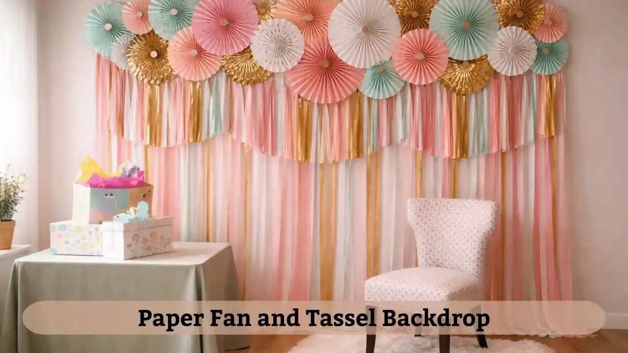 Paper fan backdrop with hanging tassels used for simple birthday decoration ideas at home in a cozy living room setup.