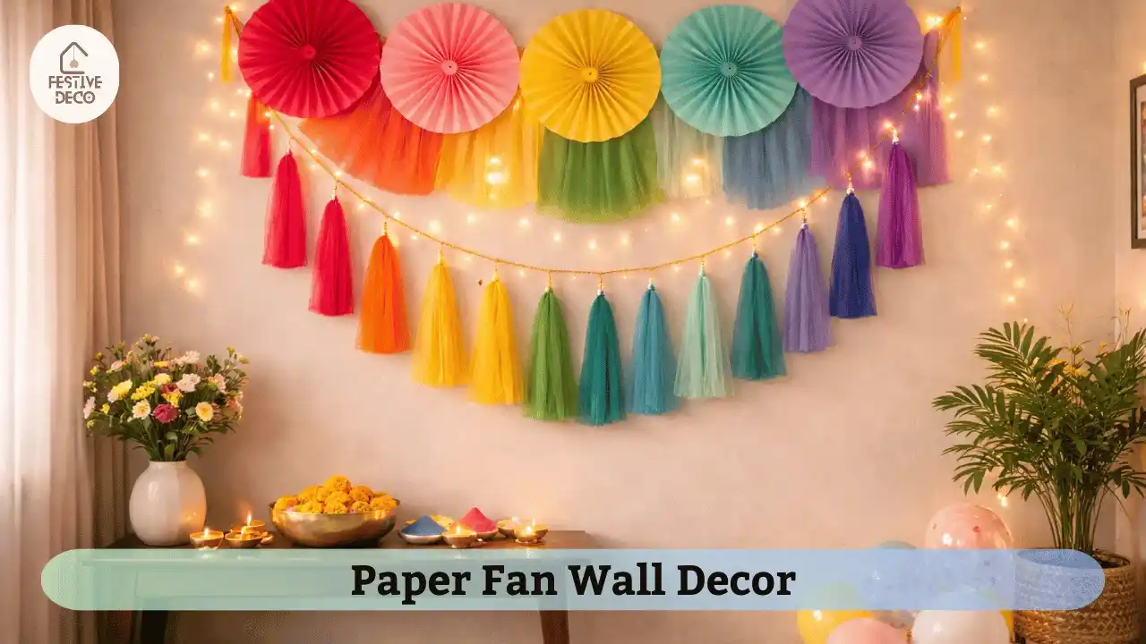 DIY Holi wall decoration using colorful paper fans and tassels in a home party setup.